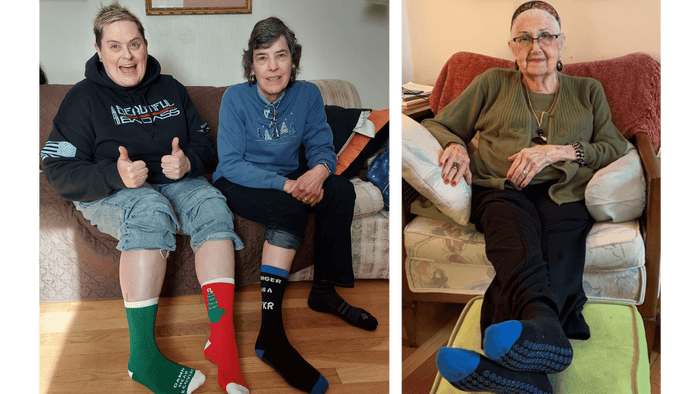 a grandma sitting at home wearing a hospital grip sock