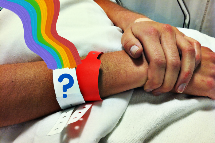 Patient wearing different colored hospital wristbands on a hospital bed