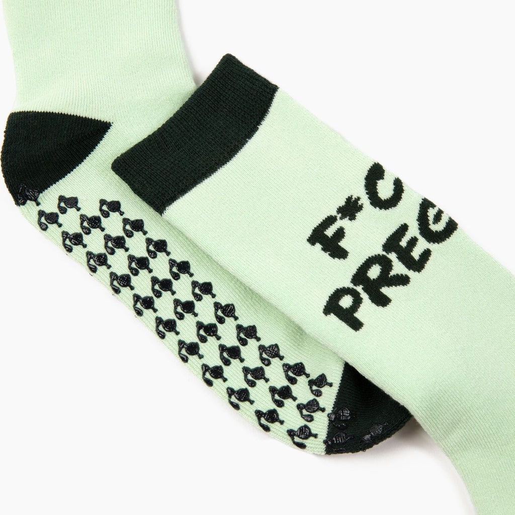 Close-up view of stork-shaped grips on the 'fck I'm pregnant' sock. Ideal gift for new mom, perfect for hospital bags or baby shower gag gifts.