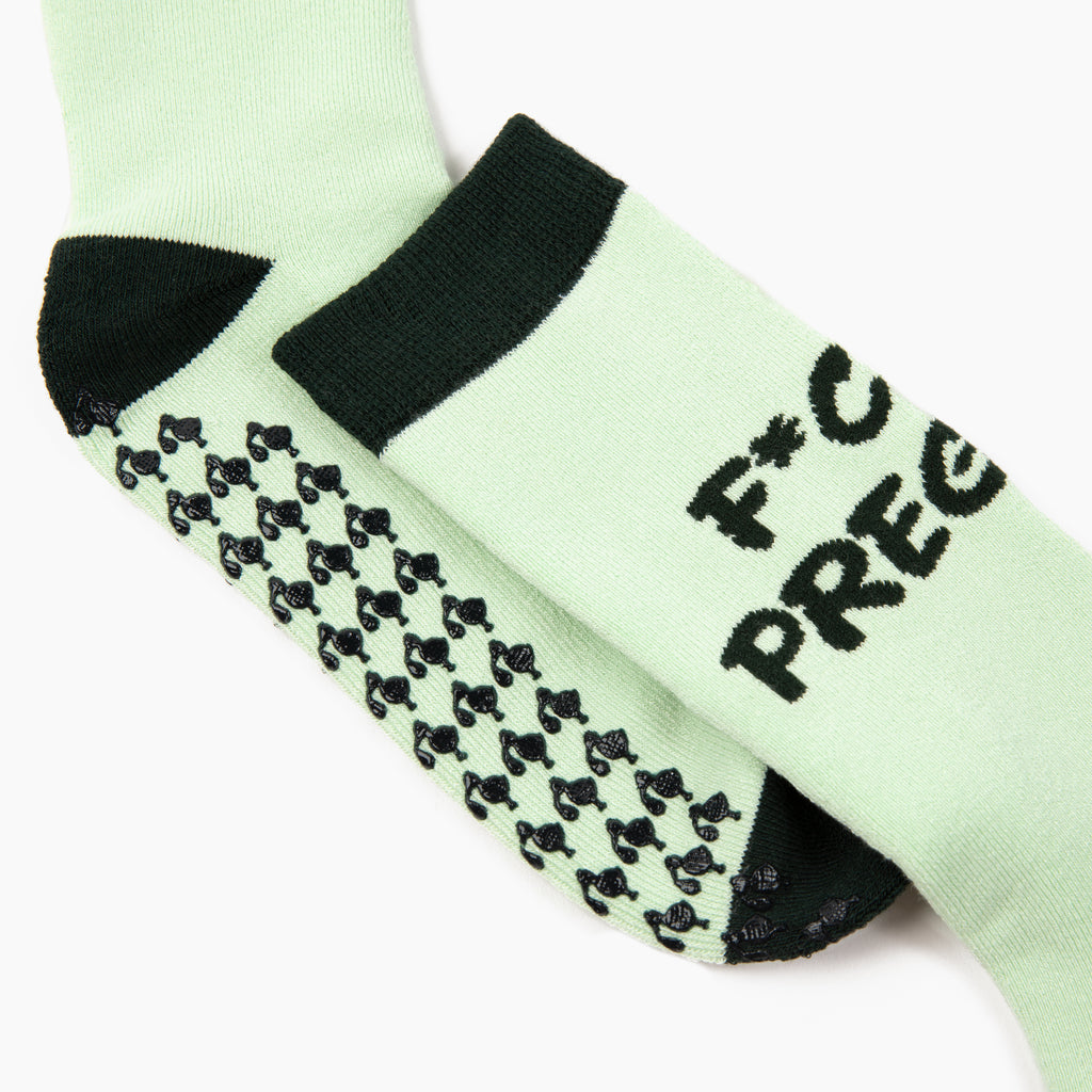 Close-up view of stork-shaped grips on the 'fck I'm pregnant' sock. Ideal gift for new mom, perfect for hospital bags or baby shower gag gifts.