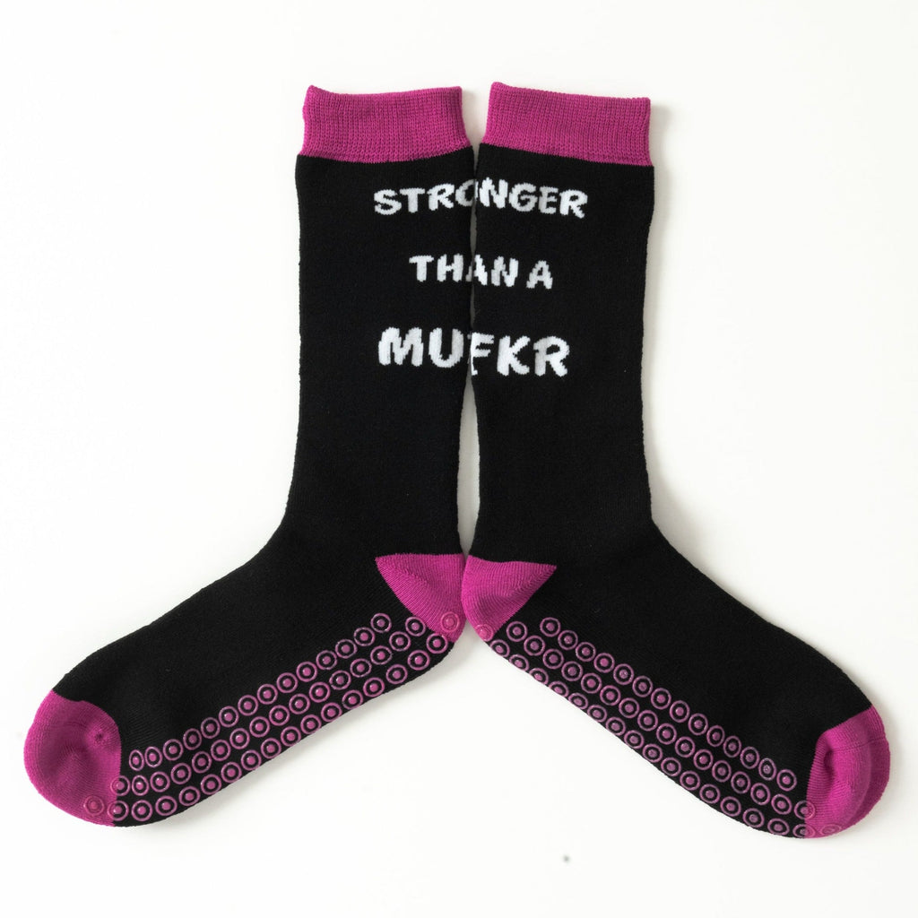 Pink hospital grip socks with 'stronger than a mufkr' text, a fun hospital gift idea, a good gift for cancer patient
