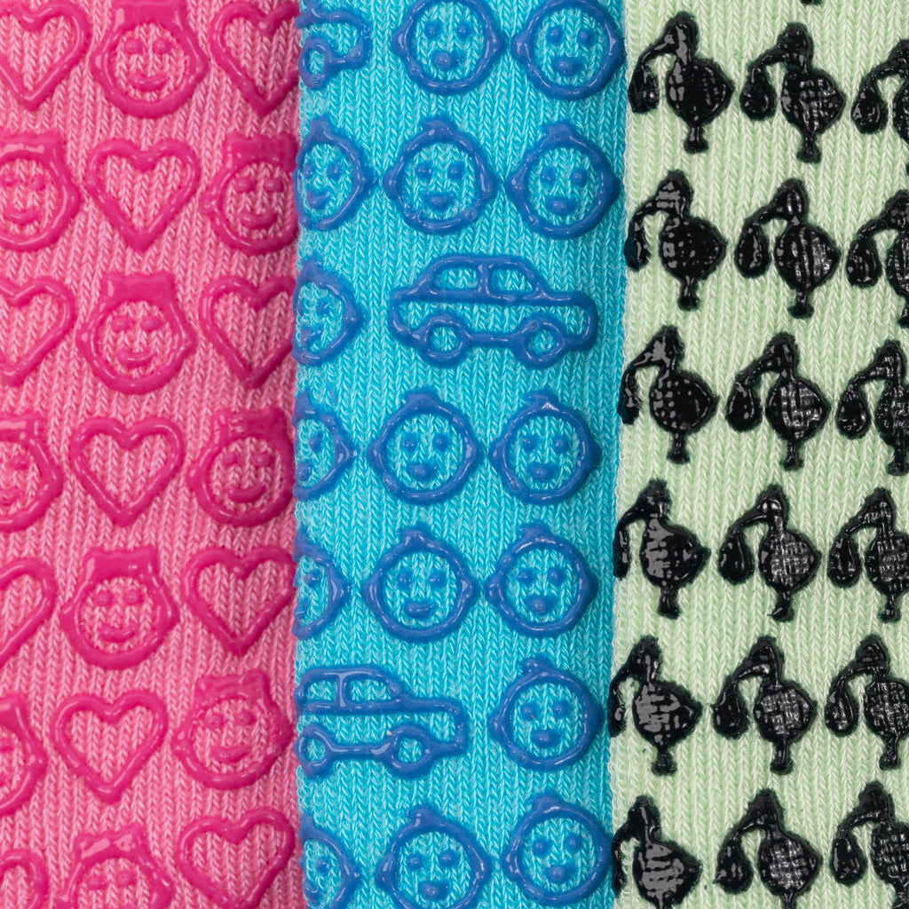 Close-up of three grip designs from the pregnant mom collection: a girl baby, a boy baby, and storks. Unique and thoughtful gift for new moms, perfect for hospital bags and baby showers.